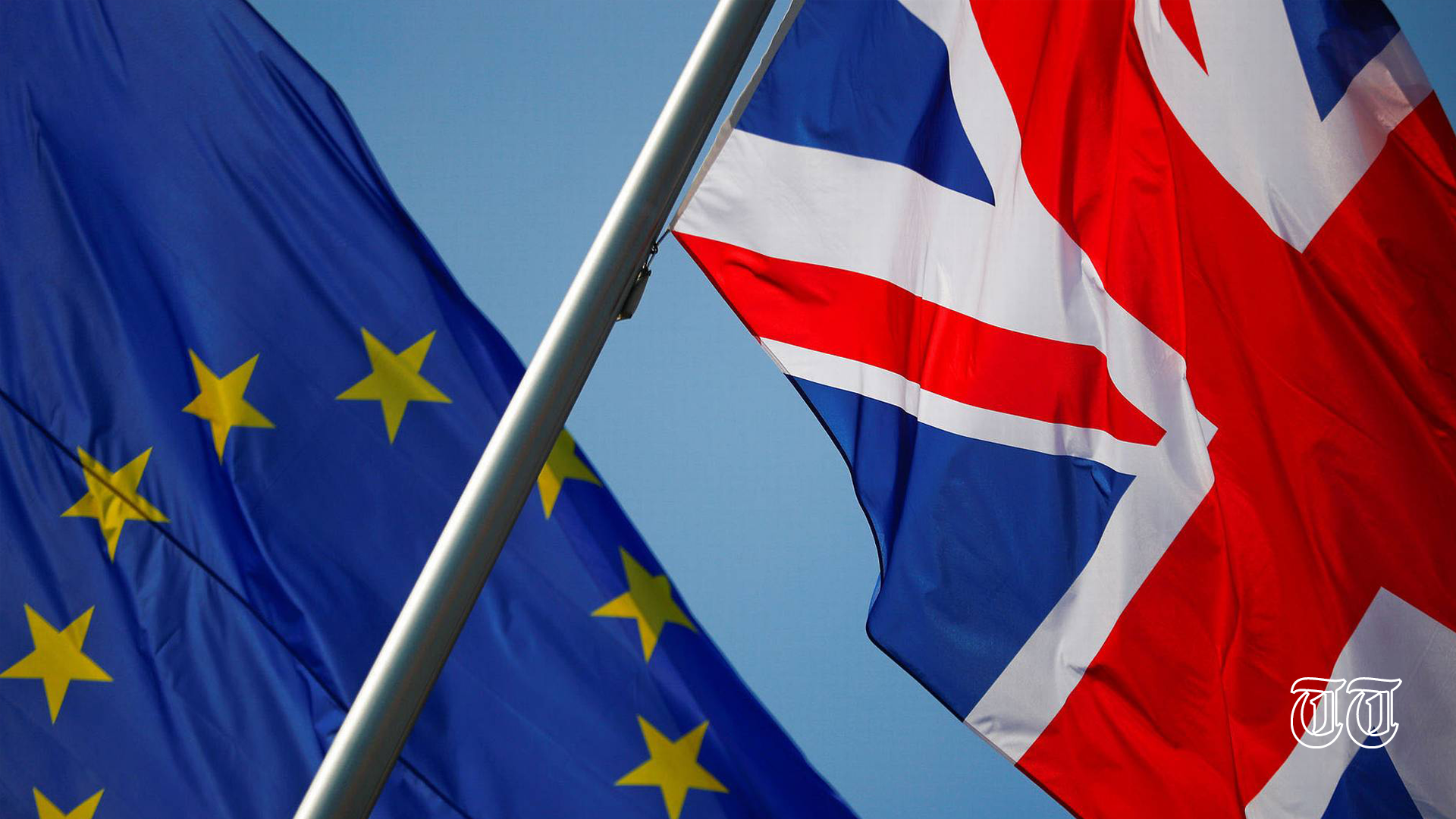 A file photo shows the flags of the United Kingdom and the European Union.