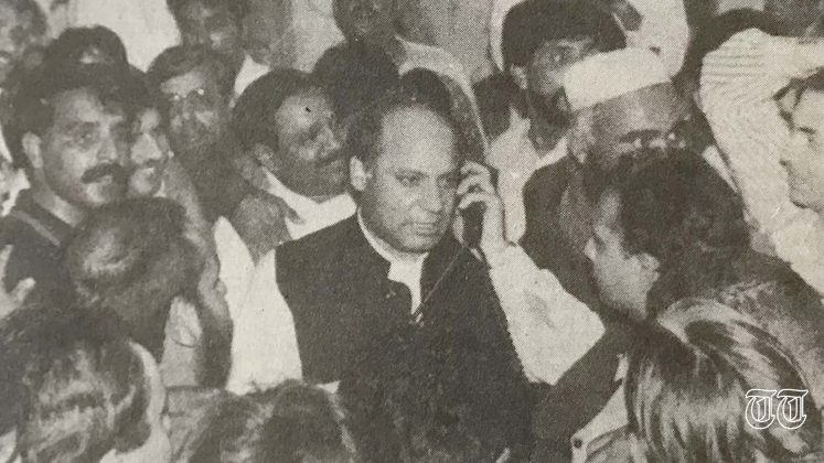 A file photo is shown of former finance minister Nawaz Sharif (C) amongst a crowd.