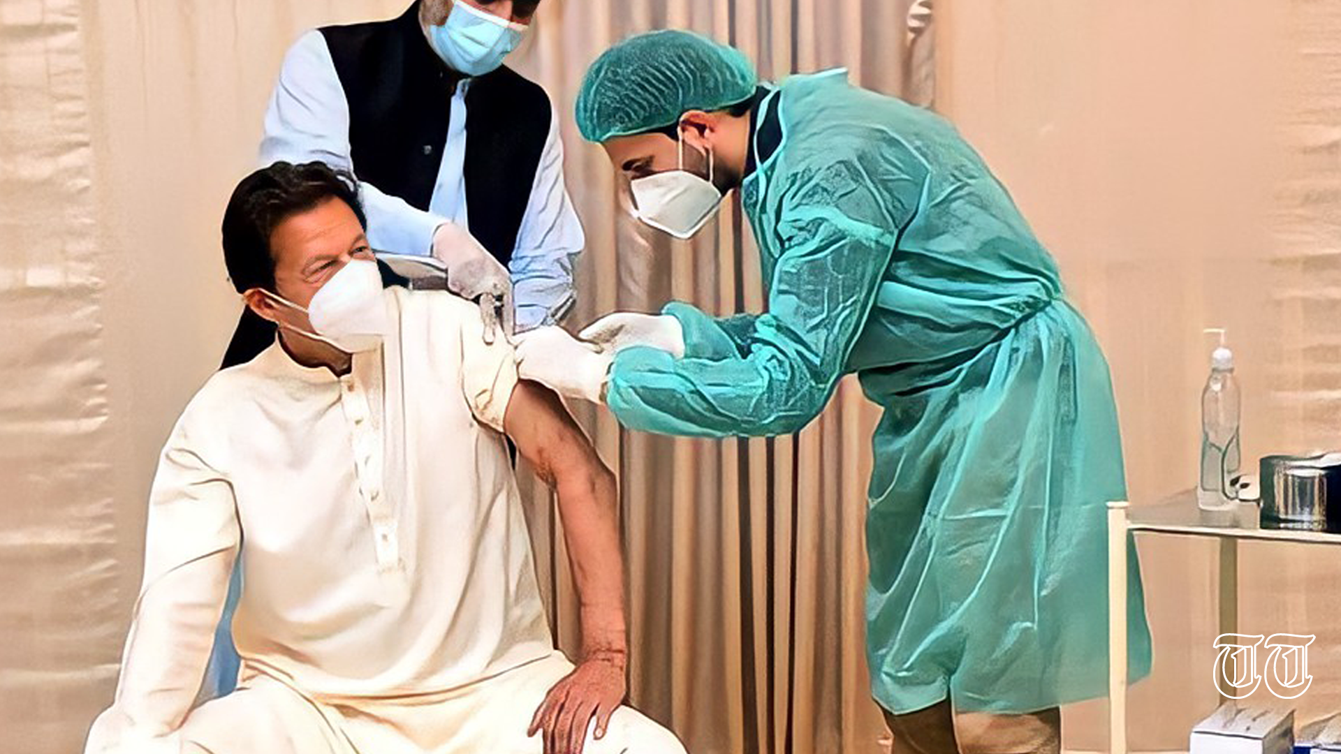A file photo of PTI chief Imran Khan receiving a vaccine is shown.