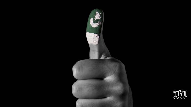 An illustration is shown of a Pakistani flag on a voter's thumb.
