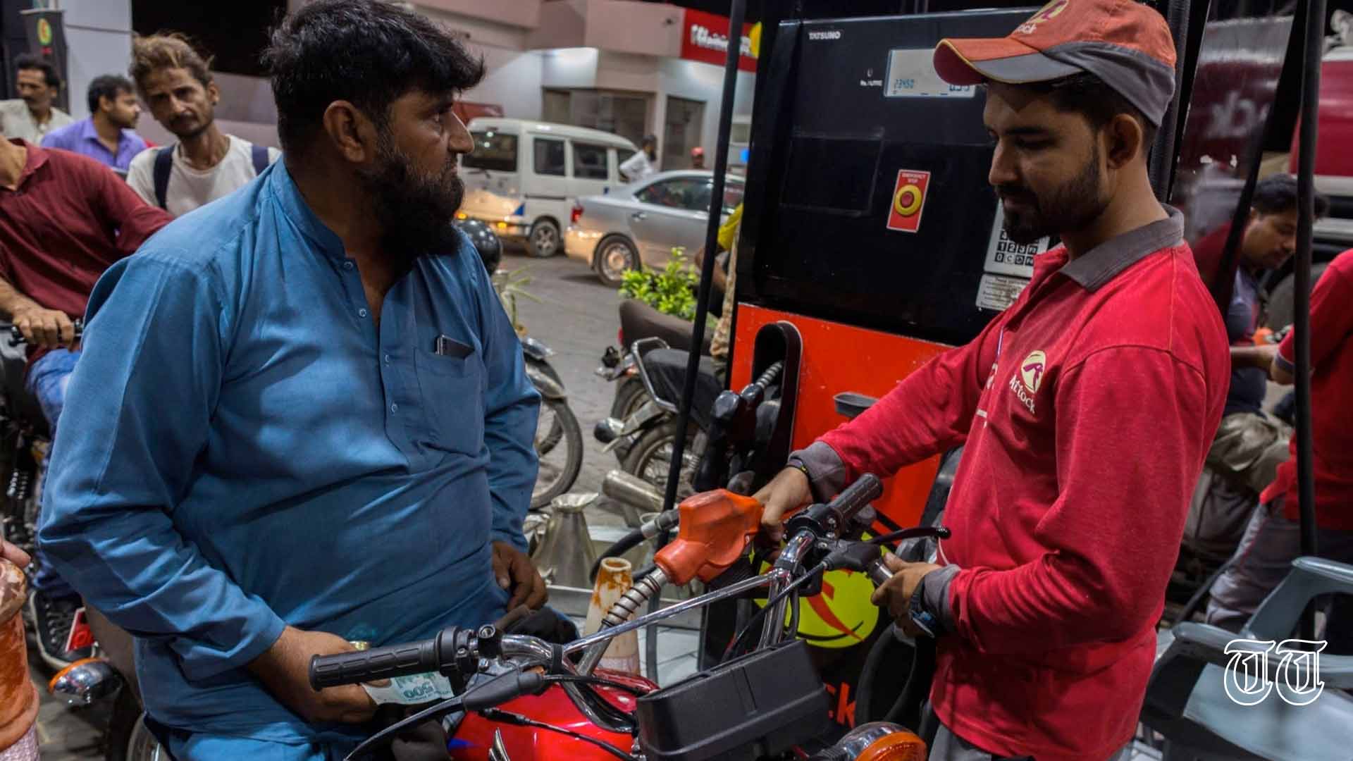 A file photo is shown of a motorcyclist fueling up at a Karachi petrol station in 2022.