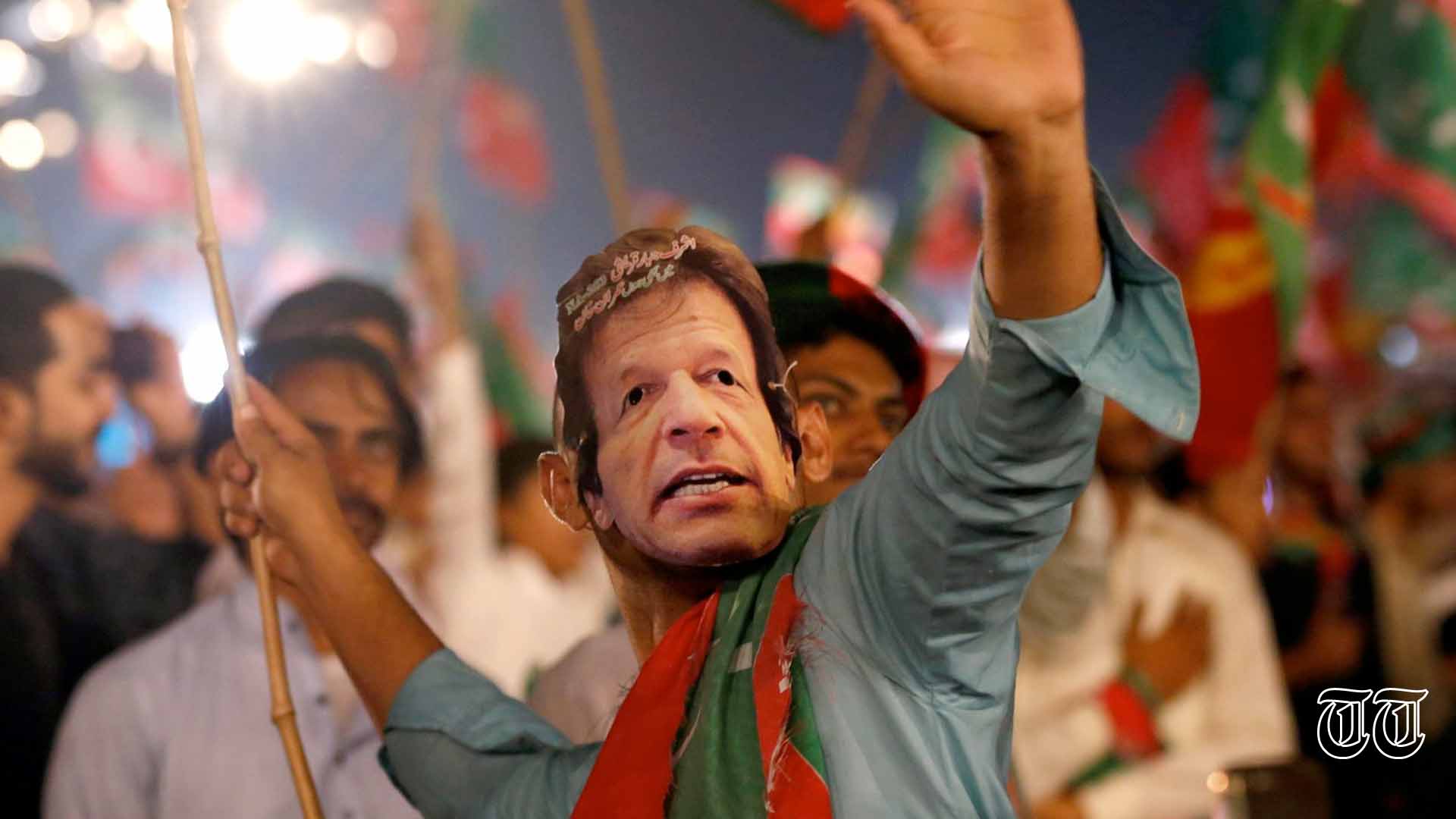 A file photo is shown of a PTI supporter at a rally.