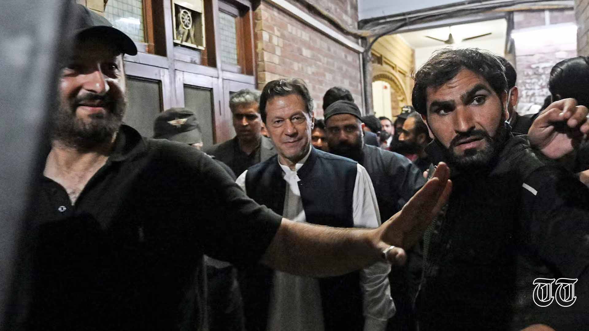 A file photo is shown of PTI chairman Imran Khan being escorted by police outside Lahore High Court.