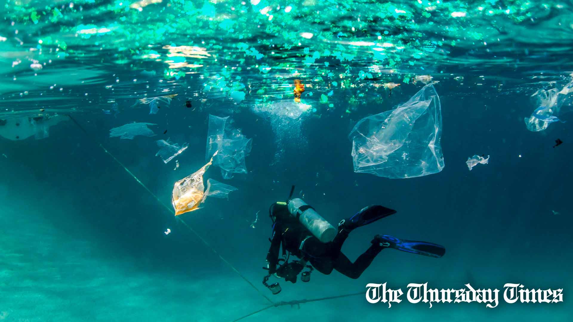 A file photo is shown of a diver swimming through plastic pollution. — FILE/THE THURSDAY TIMES