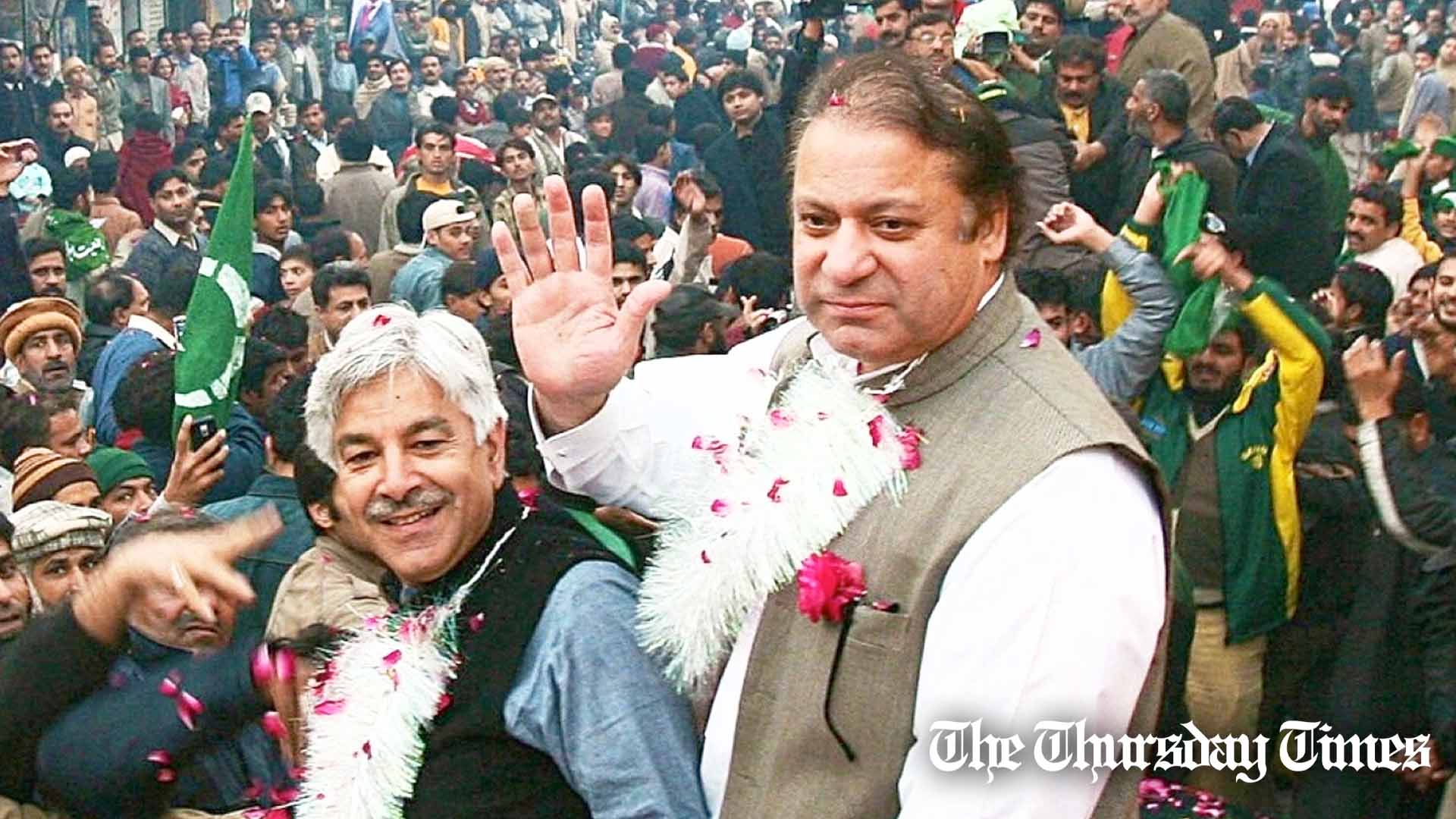Incumbent Pakistani defence minister Khawaja Asif (L) and former prime minister Nawaz Sharif (R) are shown at Sialkot in 2007. — FILE/THE THURSDAY TIMES