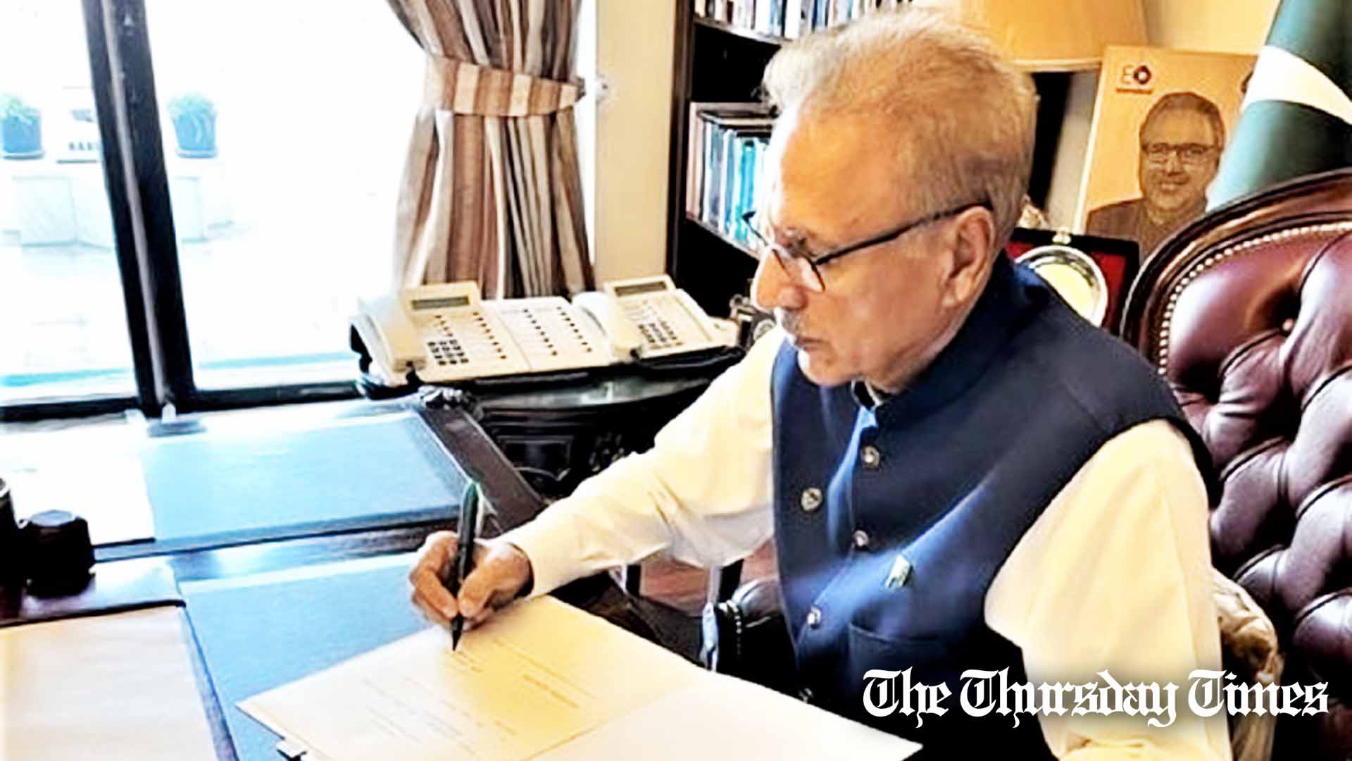 President Arif Alvi is shown signing off on a bill. — FILE/THE THURSDAY TIMES