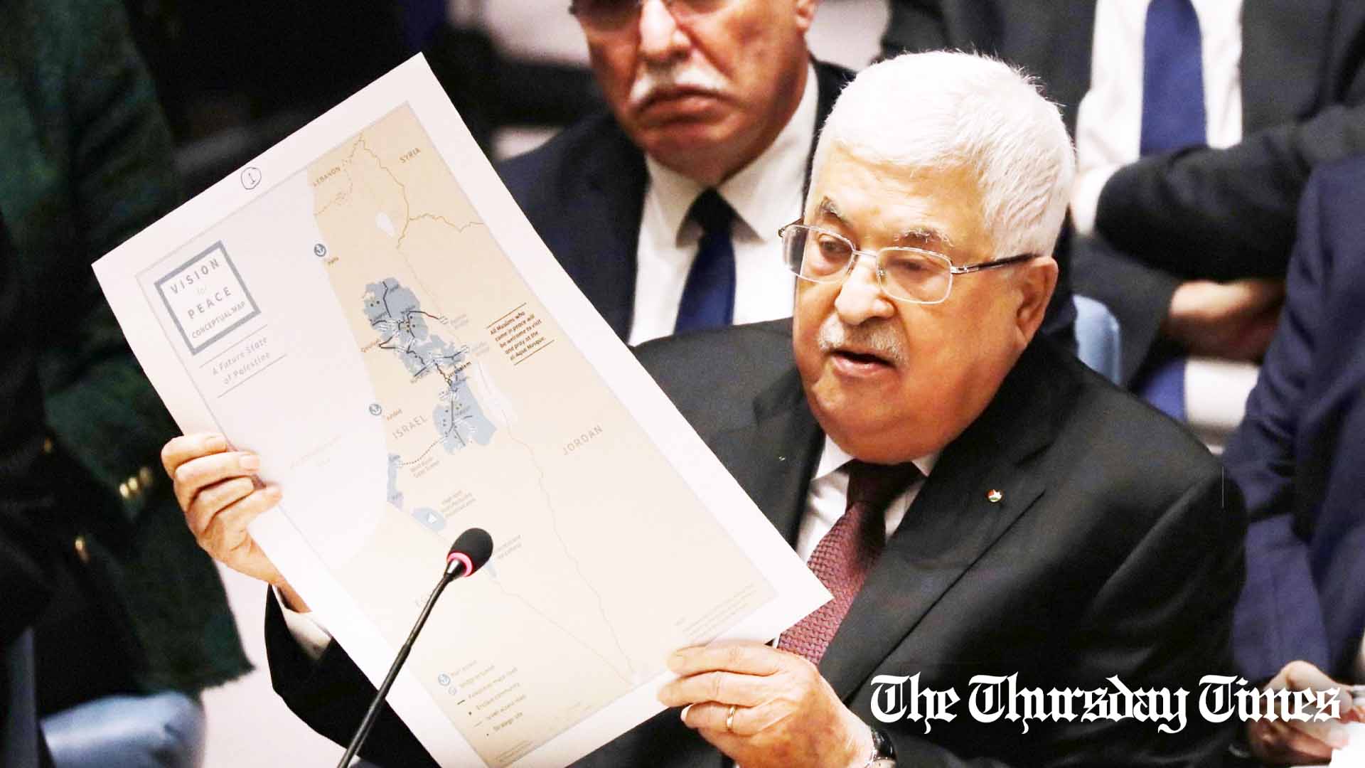 Palestinian President Mahmoud Abbas holds up a Vision for Peace map while speaking at the United Nations (UN) Security Council on February 11, 2020 in New York City. — FILE