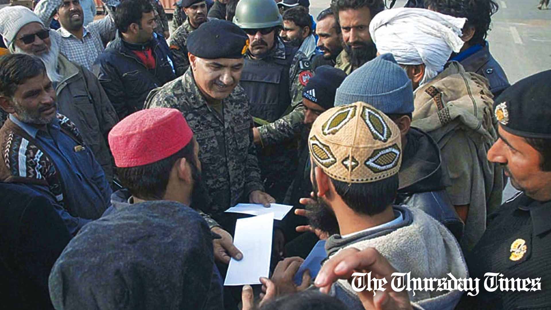 A file photo shows former Punjab Rangers Director-General, Major General Azhar Naveed Hayat Khan, distributing cash to TLP activists at the Faizabad interchange in November 2017. — FILE/THE THURSDAY TIMES