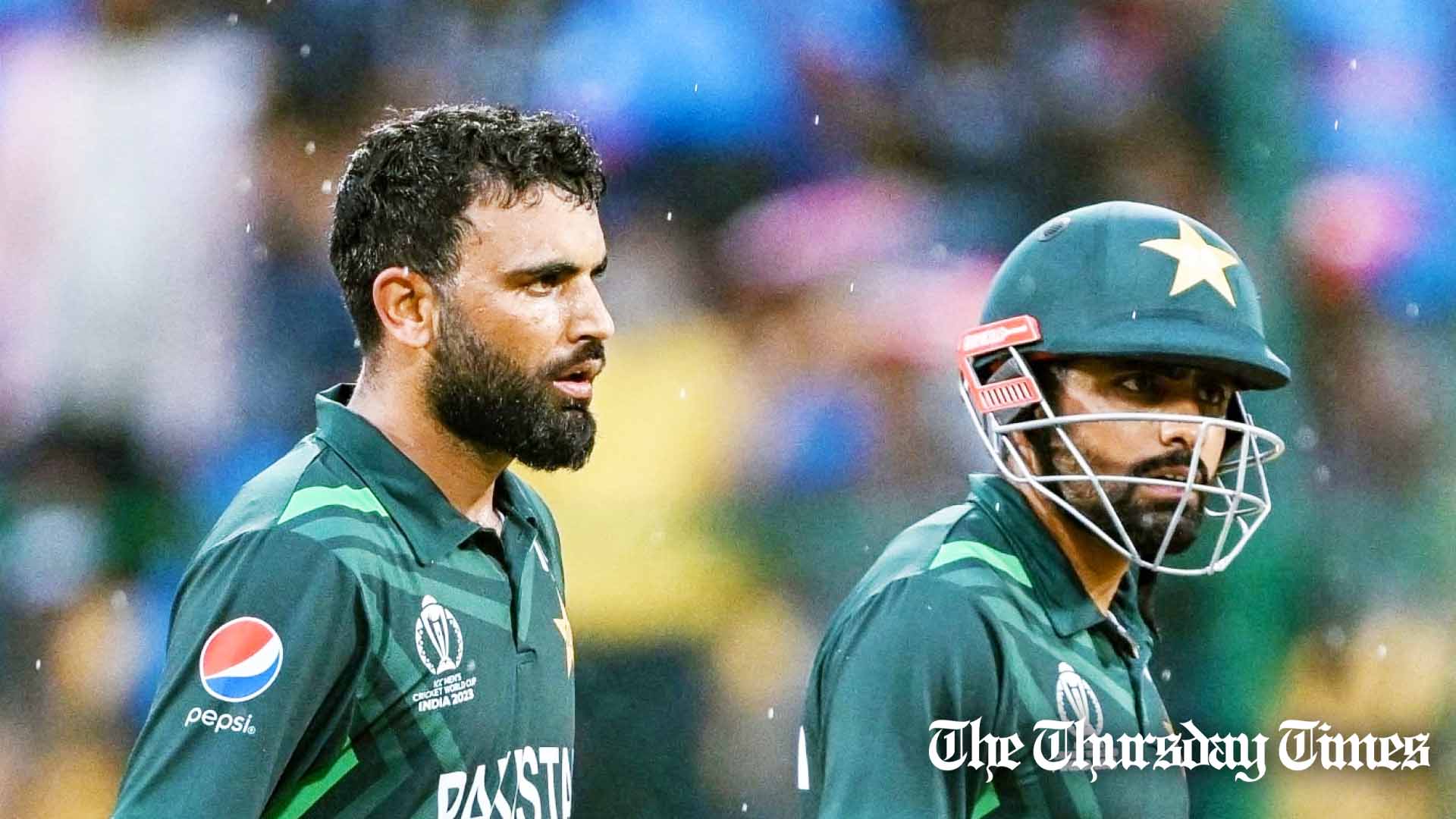 Pakistan's Fakhar Zaman and his captain Babar Azam (R) leave the field as rain stops play during the 2023 ICC Men's Cricket World Cup one-day international (ODI) match between New Zealand and Pakistan at the M. Chinnaswamy Stadium in Bengaluru on November 4, 2023. — FILE/AFP