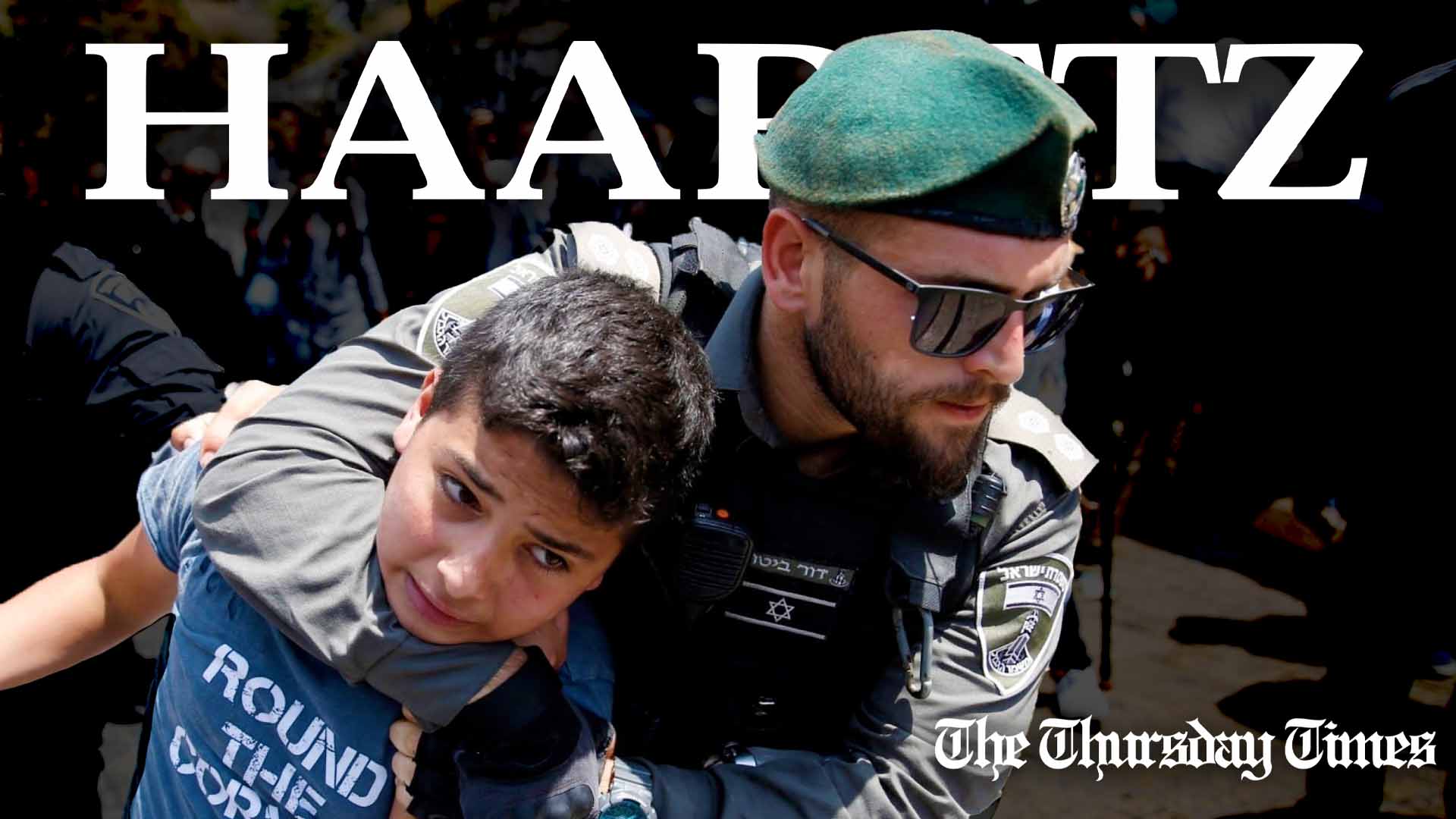 Members of the Israeli Defence Forces detain a Palestinian child during a demonstration at the Al-Aqsa mosque. — AFP