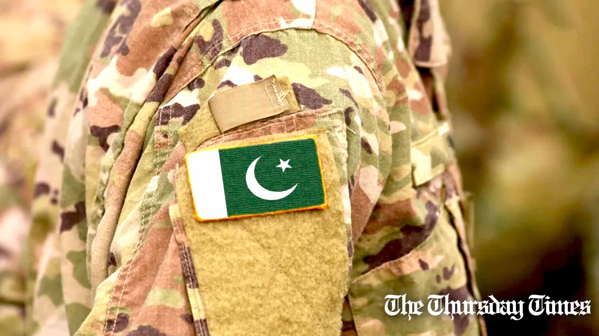 A file photo is shown of the Pakistan flag draped on an Army uniform. — FILE/THE THURSDAY TIMES