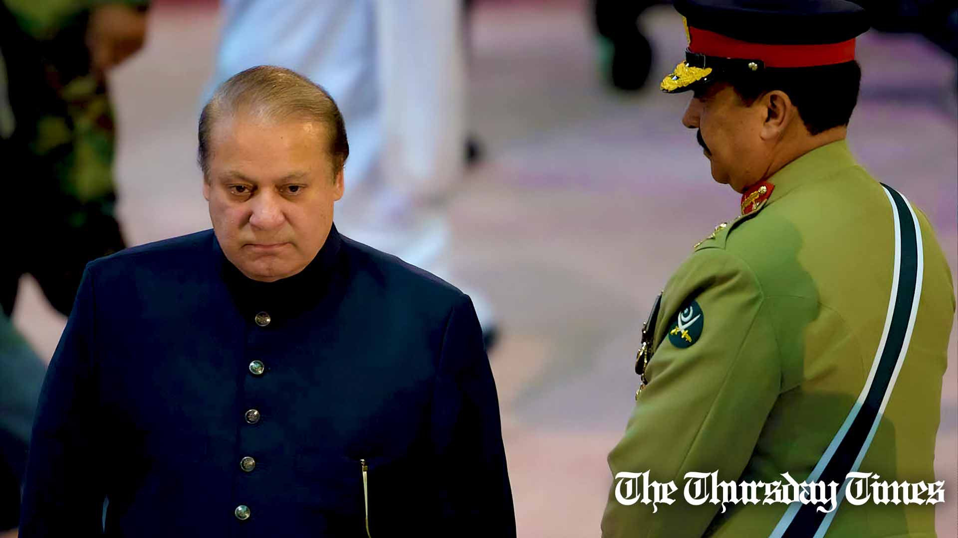 A file photo is shown of former prime minister Nawaz Sharif (L) walking past former COAS General Raheel Sharif (R) at Islamabad on August 14, 2015. — AFP